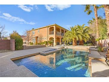 Inviting backyard pool with lush landscaping and a spacious patio, ideal for outdoor entertaining at 7258 Sashaying Spirit Ct, Las Vegas, NV 89131