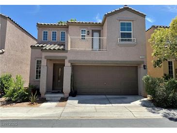 Two-story home featuring a balcony, stucco siding, and a two-car garage at 9165 Beauchamp Ave, Las Vegas, NV 89148