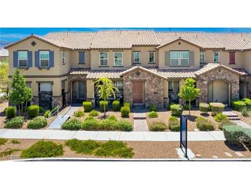 Charming townhome with stone accents, lush landscaping, and a welcoming entrance at , Henderson, NV 89044