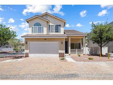 Charming two-story home featuring a two-car garage, desert landscaping, and lovely architectural details at 10348 Cherry Brook St, Las Vegas, NV 89183