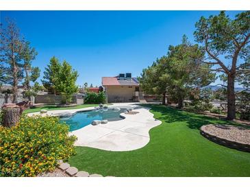 Resort-like pool featuring an elegant shape, artificial turf, and ample room for outdoor enjoyment and relaxation at 1106 E Athens Ave, Henderson, NV 89015