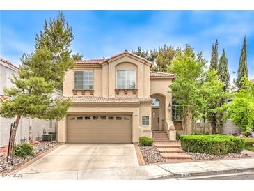 Charming two-story home featuring a well-manicured front yard and a two-car garage at 1844 Winners Cup Drive, Las Vegas, NV 89117
