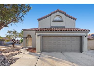 Charming stucco two-story home featuring a red tile roof and a two-car garage at 2204 W San Miguel Ave, North Las Vegas, NV 89032