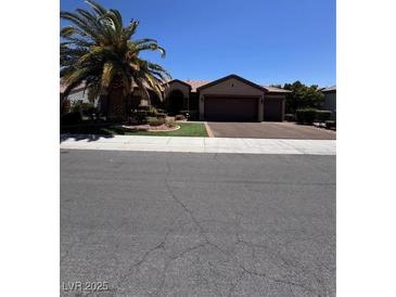 Inviting single-story home featuring a spacious three-car garage and mature landscaping at 2695 Olivia Heights Ave, Henderson, NV 89052