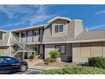 A two-story condo features gray siding, gray roof, and a metal staircase at 2785 Carnation Ln # 0, Henderson, NV 89074