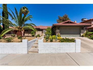 Charming single-story home featuring well-maintained landscaping, driveway, and a red tiled roof at 3826 Edmond St, Las Vegas, NV 89103