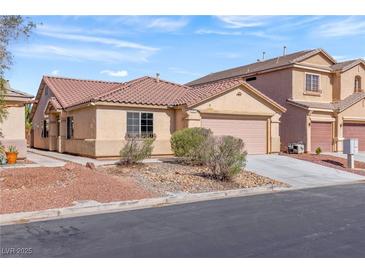Charming single-story home featuring a desert-landscaped front yard and a two-car garage, perfect for comfortable living at 4043 Lilac Creek Ct, Las Vegas, NV 89122