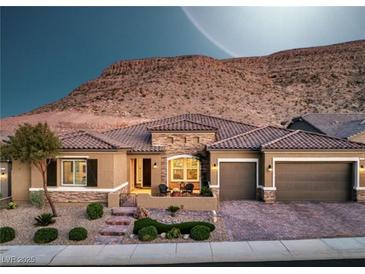 Stunning single-story home featuring a three-car garage, desert landscaping, and a beautiful mountain view at 6315 Carol Butte Ct, Las Vegas, NV 89141