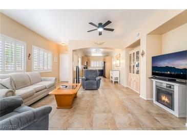 Bright living room with tile floors, fireplace, and neutral decor offers comfortable and stylish living at 7450 S Eastern Ave # 1058, Las Vegas, NV 89123