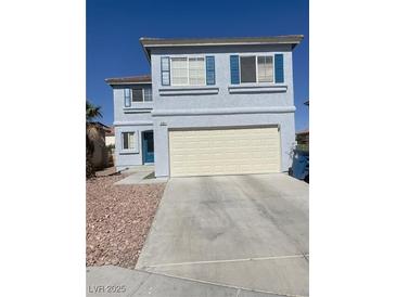 Two-story home with blue shutters and a two-car garage on a sunny day at 8484 Montana Stream Ave, Las Vegas, NV 89113