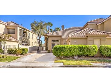 Charming single-Gathering home with well-maintained landscaping and a tile roof at 9220 Pitching Wedge Dr, Las Vegas, NV 89134