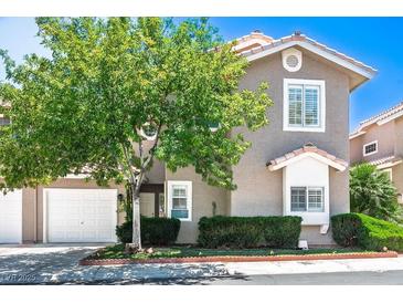 Charming townhome featuring a well-maintained front yard and attached two-car garage at 9357 Golden Timber Ln, Las Vegas, NV 89117