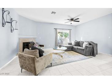 Inviting living room featuring a fireplace, plush seating, and a sliding door to the outside at 109 Breezy Tree Ct # 202, Las Vegas, NV 89145