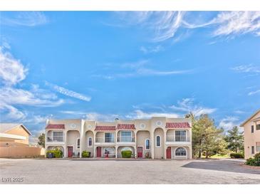 Charming multi-unit home with Spanish-style roofing and balconies under a bright blue sky at 1201 Bourbon St, Pahrump, NV 89048