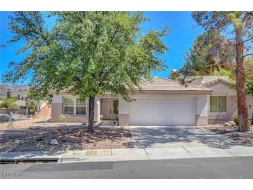 Charming single-story home featuring a two-car garage, mature tree, and well-maintained front yard in a quiet neighborhood at 2059 Joy View Ln, Henderson, NV 89012