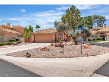 Charming single-story home featuring desert landscaping, circular driveway, and a two-car garage at 2537 Seascape Dr, Las Vegas, NV 89128