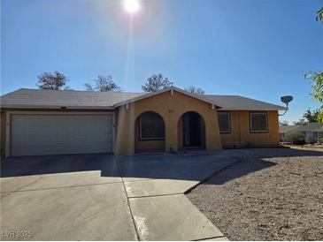 Charming single-story home with arched entry, gravel landscaping, and attached two-car garage at 256 Winona Ter, Henderson, NV 89015