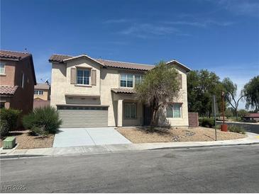 Two-story home featuring a two-car garage and drought tolerant landscaping at 3941 Copper Stone Ct, North Las Vegas, NV 89032