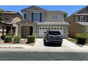 Charming two-story home featuring a two-car garage and manicured front yard at 5824 Gemstone Peak St, North Las Vegas, NV 89031