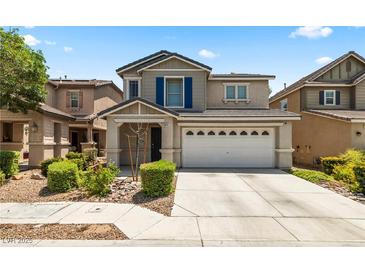 Charming two-story home featuring a well-maintained front yard and attached two car garage in a suburban community at 5824 Gemstone Peak St, North Las Vegas, NV 89031