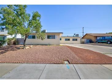Single story home boasts a spacious front yard with gravel and a lush green tree at 6317 Alta Dr, Las Vegas, NV 89107