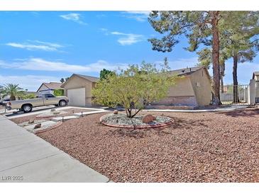 Inviting front yard with mature landscaping and a well-maintained exterior at 7113 Carrondale Way, Las Vegas, NV 89128
