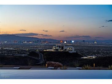 Enjoy stunning Las Vegas city views from this modern home with an infinity pool overlooking the vibrant skyline at 720 Dragon Peak Dr, Henderson, NV 89012