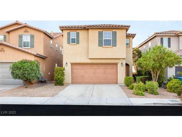 Inviting two-story home featuring a well-maintained front yard and attached two-car garage at 8930 W Ford Ave, Las Vegas, NV 89148