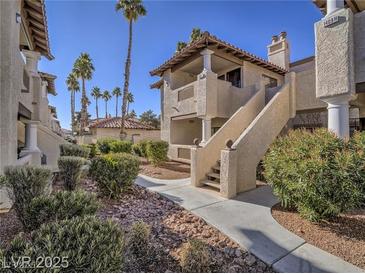 Attractive two-story condo building with stairs, stucco siding and desert landscaping at 1409 Santa Margarita St # G, Las Vegas, NV 89146