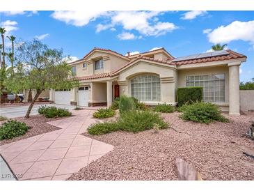 Inviting two-story home with a three-car garage, desert landscaping and stylish architectural details at 2010 Catalina Marie Ave, Henderson, NV 89074