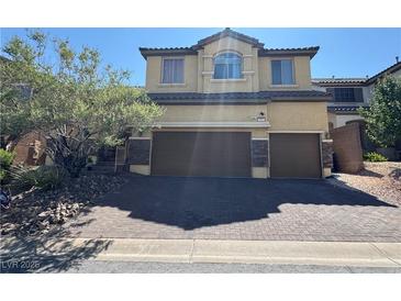Charming two-story home features a two-car garage and desert landscaping, enhancing curb appeal at 252 Quail Ranch Dr, Henderson, NV 89015