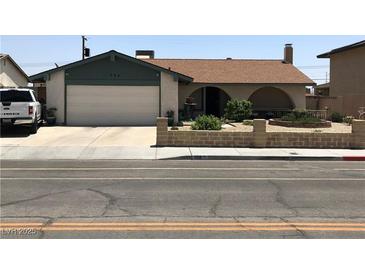 Charming single-story home featuring a two-car garage and a quaint front yard, perfect for curb appeal at 308 Sunbeam Dr, Las Vegas, NV 89107