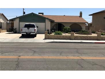Charming single story home featuring a front yard with mature landscaping and an attached two-car garage at 308 Sunbeam Dr, Las Vegas, NV 89107