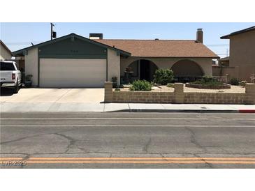 Charming single-story home featuring an attached garage, well-maintained landscaping, and a welcoming front porch at 308 Sunbeam Dr, Las Vegas, NV 89107