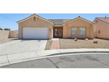 Inviting single-story home with neutral stucco, tiled roof, desert landscaping, and a convenient two-car garage at 3538 Canter Dr, North Las Vegas, NV 89032