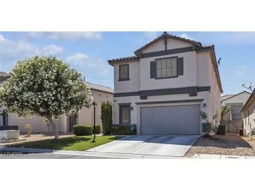 Charming two-story home with a well-manicured lawn and mature flowering tree at 4435 Peaceful Harbor St, Las Vegas, NV 89129