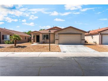 Charming single-story home with low maintenance landscaping and a two-car garage at 4837 River Splash Ave, Las Vegas, NV 89131