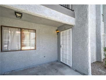 Exterior of home features a window and storm door entrance at 5219 Caliente St # 11, Las Vegas, NV 89119