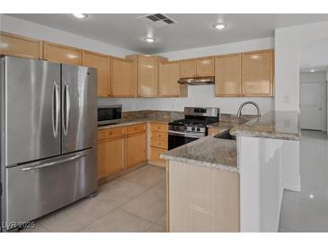 Bright kitchen features granite countertops and stainless steel appliances at 575 Aspen Leaf St, Las Vegas, NV 89144