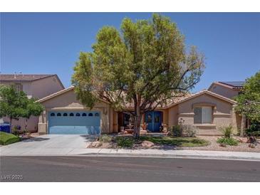 Charming single-story home with a well-manicured front yard and a delightful desert landscape at 5896 Shining Moon Ct, Las Vegas, NV 89131