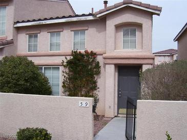 Charming two-story townhome featuring a front door and manicured landscaping at 59 Belle Maison Ave, Las Vegas, NV 89123
