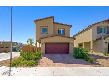Two-story home with a well-kept yard and a two-car garage, showcasing modern architecture in a residential neighborhood at 7730 Moore Creek Ln, North Las Vegas, NV 89084