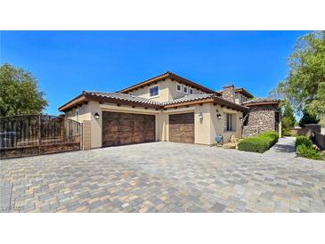 Stunning two-story home featuring a tile roof, stucco walls, stone accents, and an inviting three-car garage at 8010 Palm Cove Ct, Las Vegas, NV 89129