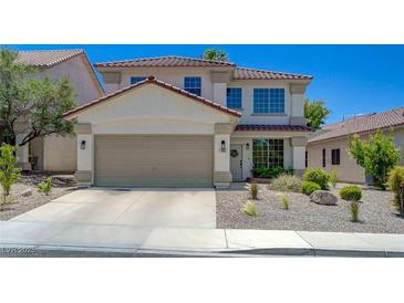 Charming two-story home features a two car garage, desert landscaping, and tile roof at 189 Andada Dr, Henderson, NV 89012