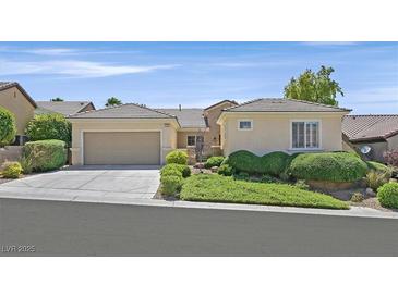 Charming single-story home with a well-manicured lawn and attached two-car garage at 2385 Orangeburg Pl, Henderson, NV 89044