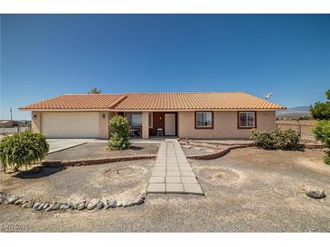 Charming single-story home with well-maintained landscaping and a tile roof at 2730 Banyon St, Pahrump, NV 89048