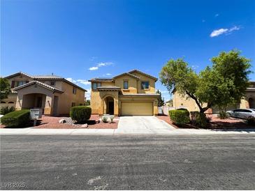 Charming two-story home featuring a well-manicured lawn, desert landscaping, and attached two car garage at 3412 Catherine Mermet Ave, North Las Vegas, NV 89081