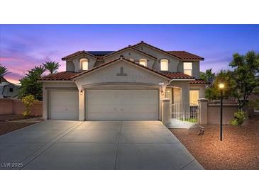 Charming two-story home with a red tile roof, three-car garage, and desert landscaping at 4021 Mountain Trek St, Las Vegas, NV 89129