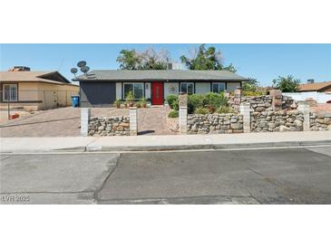 Charming single-story home with brick driveway, stone accents, and vibrant front yard landscaping at 4027 Maple Hill Rd, Las Vegas, NV 89115