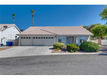 Charming single-story home featuring a three-car garage and desert landscaping at 825 Royal Moon Ave, Las Vegas, NV 89123